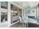 Relaxing balcony with table and chairs, offering views of the surrounding neighborhood at 5127 Melbourne St # F-204, Port Charlotte, FL 33980