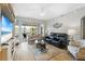 Relaxing living room with hardwood floors, comfortable seating and access to balcony at 5127 Melbourne St # F-204, Port Charlotte, FL 33980