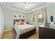 Light and airy bedroom with a queen-size bed and wood flooring at 5127 Melbourne St # F-204, Port Charlotte, FL 33980