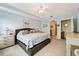 Primary bedroom with king-size bed and access to bathroom at 5127 Melbourne St # F-204, Port Charlotte, FL 33980
