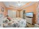 Bright bedroom with a floral bedspread and built-in wardrobe at 5127 Melbourne St # F-204, Port Charlotte, FL 33980