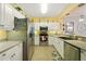Condo kitchen with white cabinets and stainless steel appliances at 5127 Melbourne St # F-204, Port Charlotte, FL 33980