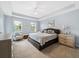 Bright Primary bedroom featuring a king bed and sitting area at 5127 Melbourne St # F-204, Port Charlotte, FL 33980