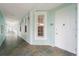 Condo hallway with tiled floors and light teal walls at 5127 Melbourne St # F-204, Port Charlotte, FL 33980