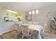 Open concept dining area with kitchen view and hardwood floors at 5127 Melbourne St # F-204, Port Charlotte, FL 33980