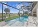 Inviting pool area with screened enclosure, spa, and outdoor kitchen at 675 Monaco Dr, Punta Gorda, FL 33950