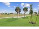 Landscaped green space with a scenic golf course view at 675 Monaco Dr, Punta Gorda, FL 33950