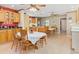 Kitchen dining area with light wood cabinets, round table, and tile floor at 6161 Riverside Dr, Punta Gorda, FL 33982