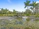 Serene pond with gazebo and lush landscaping at 6161 Riverside Dr, Punta Gorda, FL 33982