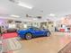 Garage with a blue Corvette and carpeted floor at 6161 Riverside Dr, Punta Gorda, FL 33982