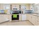 White kitchen cabinets and stainless steel appliances at 3341 Rock Creek Dr, Port Charlotte, FL 33948
