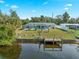 Backyard view of canal-front home with pool and dock at 3341 Rock Creek Dr, Port Charlotte, FL 33948