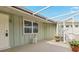 Covered patio with a side entrance to the home and potted plants at 3341 Rock Creek Dr, Port Charlotte, FL 33948