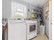Laundry room with washer, dryer, and storage shelves at 3341 Rock Creek Dr, Port Charlotte, FL 33948
