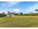 Large backyard with grassy area and a view of the house at 176 Jennifer Dr, Rotonda West, FL 33947