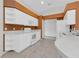 White kitchen with stainless steel appliances and tile floor at 176 Jennifer Dr, Rotonda West, FL 33947