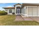 Front entrance with walkway and mature landscaping at 176 Jennifer Dr, Rotonda West, FL 33947