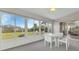 Sunroom with backyard view and white wicker furniture at 176 Jennifer Dr, Rotonda West, FL 33947