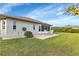 Backyard with patio, grassy area, and lush landscaping at 176 Jennifer Dr, Rotonda West, FL 33947