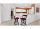 Bright kitchen features white cabinets,corian countertops and breakfast bar at 176 Jennifer Dr, Rotonda West, FL 33947