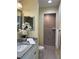 Bathroom featuring modern finishes, granite countertop vanity, decorative mirror, and walk-in tiled shower at 22235 Albany Ave, Port Charlotte, FL 33952