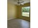 Bright bedroom featuring neutral paint, large window, tiled floor and ceiling fan at 22235 Albany Ave, Port Charlotte, FL 33952