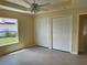 Bedroom featuring neutral walls, two closets, a ceiling fan, and a large window at 22235 Albany Ave, Port Charlotte, FL 33952