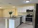 Open kitchen with granite countertops, stainless steel appliances, and a bar-height island at 22235 Albany Ave, Port Charlotte, FL 33952