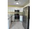 Bright kitchen featuring stainless steel appliances, granite countertops, and white cabinets at 22235 Albany Ave, Port Charlotte, FL 33952