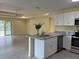 Modern kitchen with stainless steel appliances, granite countertops and an island with bar seating at 22235 Albany Ave, Port Charlotte, FL 33952