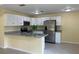 Well-lit kitchen with stainless steel appliances, granite countertops, and crisp white cabinetry at 22235 Albany Ave, Port Charlotte, FL 33952