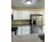Modern kitchen with stainless steel refrigerator, microwave and granite countertops at 22235 Albany Ave, Port Charlotte, FL 33952