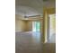 Bright living room with a tray ceiling, a ceiling fan, and sliding glass doors leading to the outdoor area at 22235 Albany Ave, Port Charlotte, FL 33952