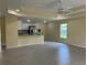Open-concept living space featuring tile flooring, a ceiling fan, and a view into the kitchen at 22235 Albany Ave, Port Charlotte, FL 33952