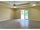 Spacious living area with tiled floors and sliding glass doors to the outdoors at 22235 Albany Ave, Port Charlotte, FL 33952