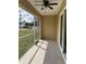 Enclosed patio featuring tile floors, ceiling fan, and screen windows to provide a relaxing outdoor living space at 22235 Albany Ave, Port Charlotte, FL 33952