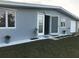 View of home's fresh exterior with large windows, well manicured yard and front entrance at 4127 Gardner Dr, Port Charlotte, FL 33952