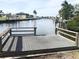 Private dock with peaceful waterfront views and lush vegetation at 4127 Gardner Dr, Port Charlotte, FL 33952