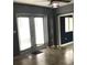 Living room with tile floors, french doors, and ceiling fan at 4127 Gardner Dr, Port Charlotte, FL 33952