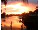 Stunning sunset view over the canal, boats and docks visible at 4127 Gardner Dr, Port Charlotte, FL 33952