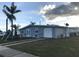 Newly renovated home showcasing a modern exterior and landscaping at 4127 Gardner Dr, Port Charlotte, FL 33952