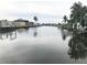 Tranquil canal view with waterfront homes and lush tropical foliage at 4127 Gardner Dr, Port Charlotte, FL 33952
