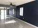 Living room with tiled floors, sliding doors, and ceiling fan at 4127 Gardner Dr, Port Charlotte, FL 33952
