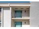 Condo entryway with teal doors and balcony at 1439 Mediterranean Dr # C, Punta Gorda, FL 33950