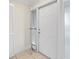 White front door with a storm door and pet door at 1439 Mediterranean Dr # C, Punta Gorda, FL 33950