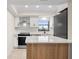 Modern kitchen with white cabinets and quartz countertops at 1439 Mediterranean Dr # C, Punta Gorda, FL 33950