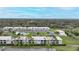 Aerial view of condo community showing building, pool, and surrounding area at 26485 Rampart Blvd # D28, Punta Gorda, FL 33983