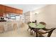 Dining area with glass-top table and wicker chairs near kitchen at 26485 Rampart Blvd # D28, Punta Gorda, FL 33983