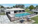 Community pool with lounge chairs and tables at 26485 Rampart Blvd # D28, Punta Gorda, FL 33983