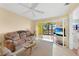 Living room with a comfortable couch, coffee table, and access to a patio at 26485 Rampart Blvd # D28, Punta Gorda, FL 33983